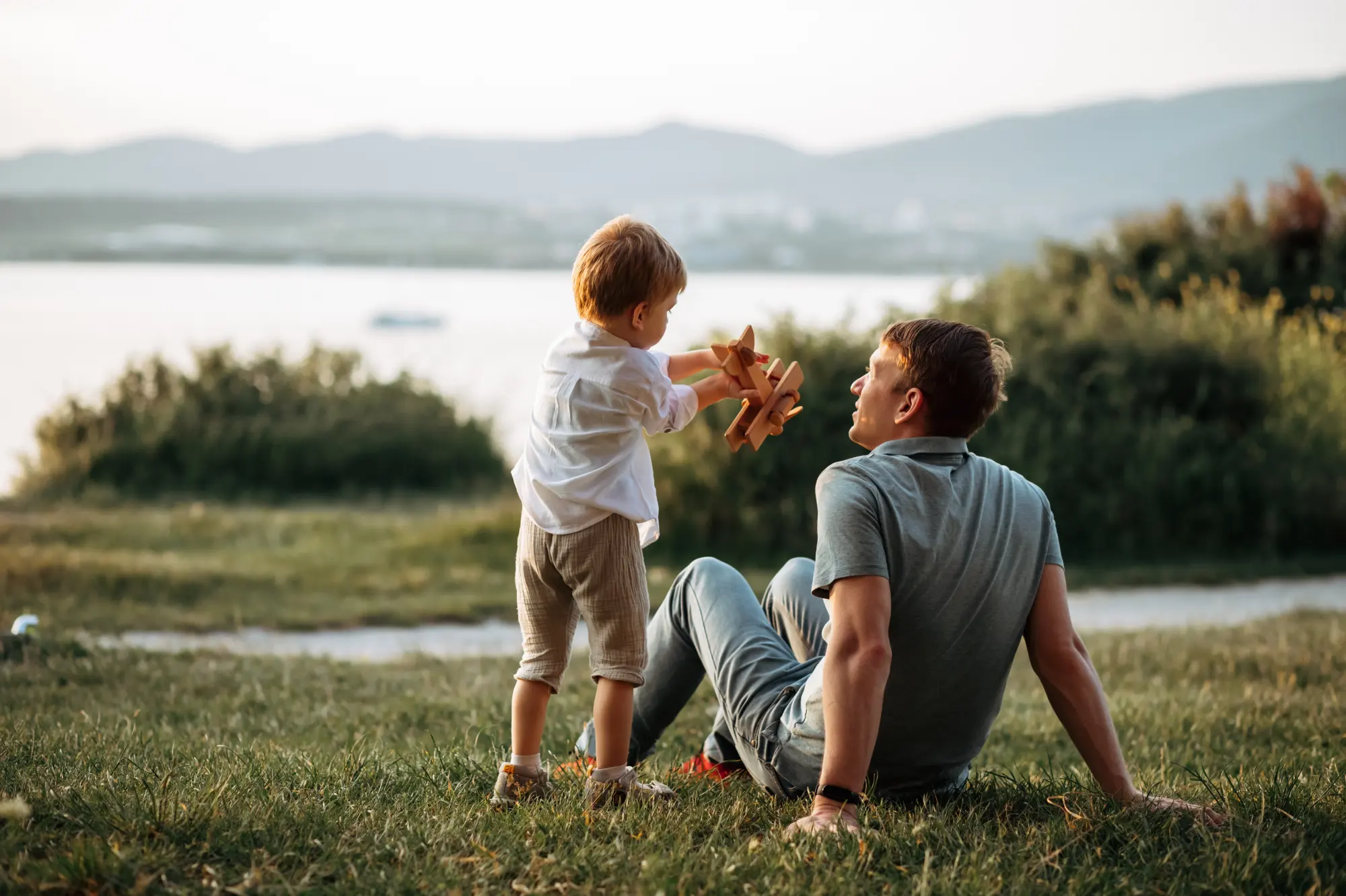 dad and son play on the seashore, vacation with children